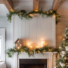 a fireplace decorated for christmas with candles and greenery