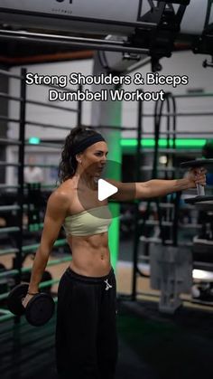 a woman holding a kettle while standing in front of a gym equipment rack with the words strong shoulders and biceps dumbbell workout