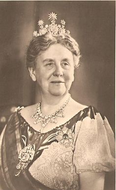 an old black and white photo of a woman wearing a tiara