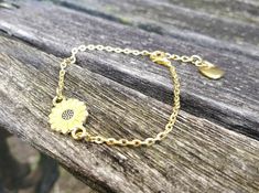 "This bracelet is perfect for anyone! You can choose a yellow sunflower or a white daisy. The metal is a gold color. The flower measures 1/2\" wide. The bracelet has an extender on it so it is adjustable, and it has a heart charm at the end. Perfect for a Mom gift, for a Christmas gift, anniversary, or a birthday. All jewelry items come in a gift box." Gold Bracelet With Birth Flower For Gift, Personalized Gold Flower Bracelets, Dainty Yellow Bracelet For Gift, Dainty Yellow Bracelet As Gift, Gold Bracelet With Birth Flower Design, Petoskey Stone, Daisy Bracelet, Memory Locket, White Daisy