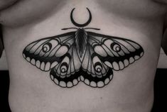 a black and white photo of a butterfly tattoo on the side of a woman's stomach