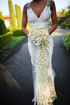 a woman in a white dress holding a bouquet