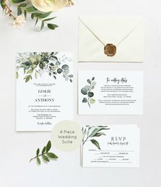 wedding stationery with greenery and white flowers