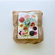 a package wrapped in brown paper with flowers on it