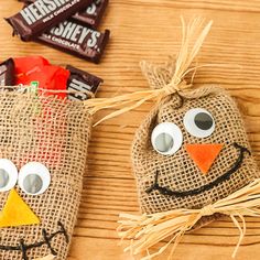 two scarecrows made out of burlap bags with candy bars in the background