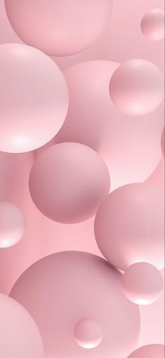 an abstract pink background with lots of bubbles in the air and on top of each other