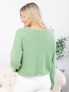 Perfect for the season ahead, we love the soft + muted tone of green that this sweater from Z Supply features! A woven LUCKY is featured front + center and is perfect for an everyday reminder, or a fun + playful look for St. Patricks Day ahead! This crew neck sweater boasts a slightly boxy and cropped design along with drop shoulders for an ultra relaxed look and feel. Z Supply Crew neck sweater Drop shoulders Boxy, cropped, + relaxed silhouette LUCKY verbiage across the front 100% Cotton Body length measurement: 19" from a S. Bust measurement: 22.5" from a S. Model is wearing a S. Trendy Green Cardigan, Trendy Green Sweater For Layering, Green Cotton Cardigan For Fall, Green Crew Neck Cardigan For Fall, Green Cotton Sweater For Spring, Spring Green Cotton Sweater, Trendy Green Soft Knit Sweater, Trendy Green Fall Sweater, Trendy Green Cardigan For Layering