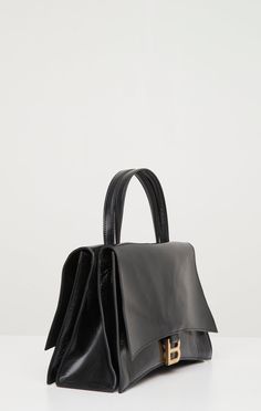 For Resort 24, Balenciaga crafted an updated take on their iconic hourglass bag. This bag features two separate pockets, B-logo hardware, top carry handles, and a crossbody strap. Balenciaga Crush Bag, Crush On You, Your Crush, Crossbody Strap, Ysl Bag, Neiman Marcus, Carry On, Balenciaga, Handles