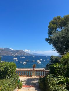 a view of the ocean and boats from an outdoor area with steps leading up to it