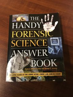 the handy forensic science answer book on a wooden table next to a pair of gloves