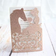 a pink and gold wedding card with a horse silhouette on the front, in glitter