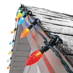 christmas lights are hanging on the side of a house's shingled gutter