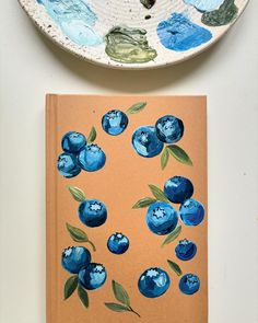 two plates with blueberries painted on them