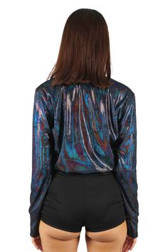 Luxuriously soft and mesmerizingly holographic our womens velvet bomber jacket in Panther is a wardrobe staple. Our Panther velvet has a stealthy holographic iridescence that is only really visible in the sun or bright lights making this cropped bomber jacket great for both festival wear and streetwear. FEATURES: Made with a holographic black velvet outer Fully lined with velvet for extra warmth and comfort Thumbhole cuffs Cropped length Deep front pockets Ethically handmade in house and 100% carbon neutral FIT NOTES:Runs true to size. This velvet bomber jacket is designed to have a snug fit at the waist. For a more relaxed fit please go one size up.Model wears size small. Iridescent Fitted Long Sleeve Outerwear, Fitted Iridescent Outerwear For Fall, Iridescent Outerwear For Fall Party, Trendy Iridescent Long Sleeve Outerwear, Holographic Black, Gloves Dress, Carbon Neutral, Bright Lights, Catsuit