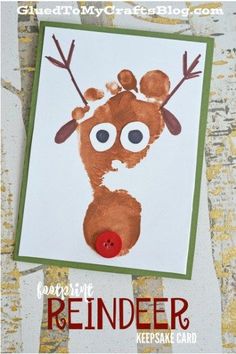 a reindeer handprinted on a white card with red nose and brown antlers