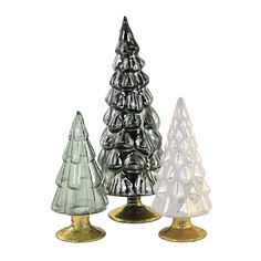 three glass christmas trees sitting next to each other