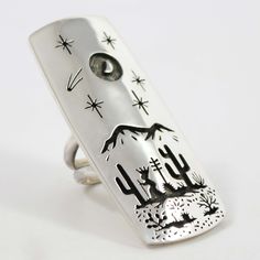 Sterling Silver Ring with an Intricate Overlaid Desert Scene Design including a Cactus Fruit Picker and a Crescent Moon in the Sky by Tohono O’Odham and Akmel O’Odham Silversmith, Rick Manuel. Ring Size: 7.25 1” Setting Width, 2.25” Setting Height .25” Band Width Cactus Fruit, Moon In The Sky, Fruit Picker, Desert Scene, Zuni Jewelry, Concho Belt, Navajo Jewelry, Scene Design, Native Jewelry