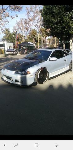 a silver car parked on the side of a road