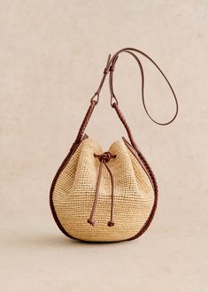 Made in our workshop in Madagascar ;Shoulder basket ;Hand-woven raffia exterior ;Non-adjustable handle ;Carried on the shoulder and crossed ;Closes with leather ties;Dimensions: 25 x 37 x 13 cm / 9.8 x 14.6 x 5.1 in Neutral Handbag, Mini Bucket Bags, Mini Bucket, Woven Raffia, Basket Bag, Card Bag, Best Bags, Bag Dress, Jewelry Packaging