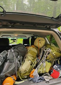 there are many bags in the back of this car and it is packed with stuff