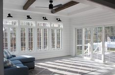 a living room with white walls and windows