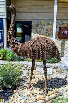 an ostrich made out of metal in front of a building