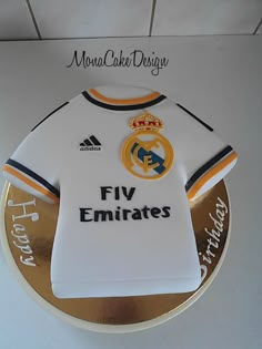 a cake shaped like a real madrid jersey is on display at the official team store