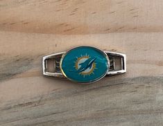 Officially Licensed Miami Dolphins Sports Charm -Metal Shoe Charm Measures Approximately 1.25-inches -Officially licensed and manufactured by Aminco International -Perfect as a shoe charm, woven into bracelet, lanyard, and more! Dolphin Logo, Miami Dolphins Logo, Miami Dolphins, The Passion, Shoe Charms, Dolphins, Lanyard, The Game, Shoe Laces