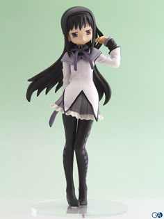 an anime figurine is posed on a white base with black hair and purple eyes