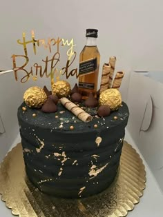 a birthday cake is decorated with liquor and candies