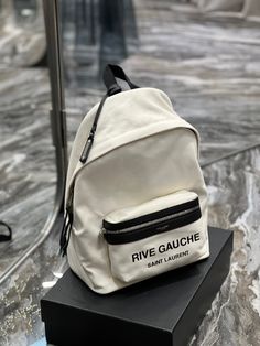 Description S.L City Backpack In Canvas Unisex For Women 13.8in/35cm White YSL Rep 1:1 Size: 26 x 35 x 16 cm/ 10.2 x 13.8 x 6.3 inches White Rive Gauche Zip closure Top handle Medium compartment Adjustable back straps Include dust bag. This product is of the best quality. Ysl Backpack, City Backpack, Yves Saint Laurent Bags, Luxury Products, Rive Gauche, Canvas Backpack, Saint Laurent Bag, Evening Clutch Bag, Tote Backpack