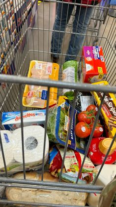 a shopping cart filled with groceries and food