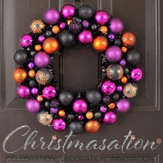 a purple and black christmas ornament wreath hanging on a door with the words christmasation written below it