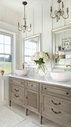 a bathroom with two sinks and green cabinets in front of a large window that looks out onto the water