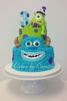 a blue and green cake with monsters on it