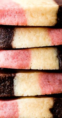 four different colored cookies stacked on top of each other