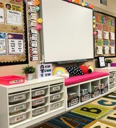 an empty classroom with lots of books and toys on the floor, along with many bulletin boards