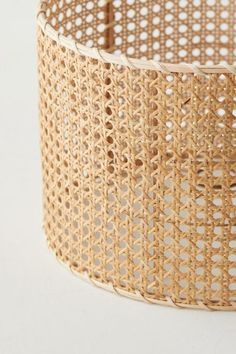 a close up of a woven basket on a white surface with no people around it