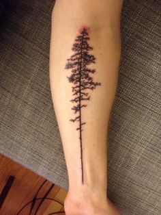 a person's foot with a tattoo on it that has a tree in the middle