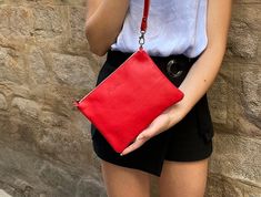 ► This holiday season we offer FREE FAST shipping to the USA! Please provide a PHONE number in a note with the order for the FedEx delivery.  This casual red small or medium leather purse is handmade with the best quality Italian cowhide leather. The resistant leather strap is adjustable so you can were it as a crossbody bag or shoulder bag. We make this light and comfortable leather purse to carry in any occasion and style, Pure RED color, a soft, smooth leather handbag with visible zipper clos Red Leather Bag With Zipper Pouch, Red Leather Clutch Pouch, Red Leather Pouch For Everyday Use, Red Leather Pouch For Gift, Soft Leather Crossbody Bag, Minimalist Purse, Red Minimalist, Casual Clutch, Red Bag