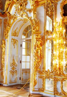 an ornately decorated room with golden mirrors