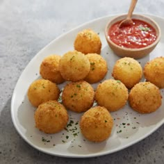 small appetizers on a plate with dipping sauce