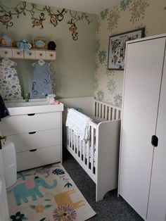 a baby's room with a crib, dresser and changing table in it