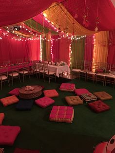 a large tent with tables and chairs set up for a party or function in the evening