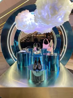 a display in a mall filled with lots of bags and purses under a cloud