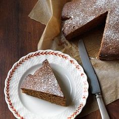 a piece of cake sitting on top of a white plate next to a knife and fork