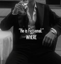 a man in a suit holding a wine glass with the caption he is fictional where