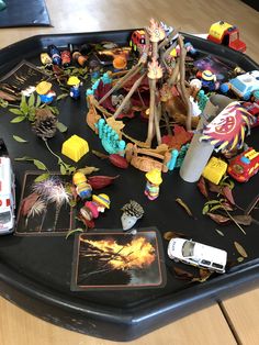 a tray filled with toys on top of a wooden table