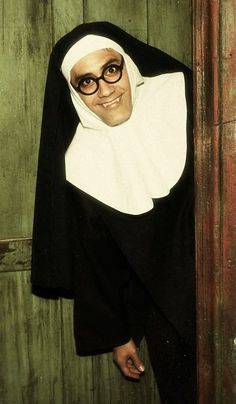 a nun in black and white is posing for the camera