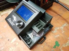 an electronic device sitting on top of a wooden table